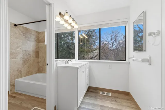 a view of a bathroom with a tub and a shower