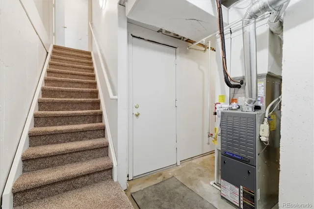 a view of closet with wooden floor and stairs