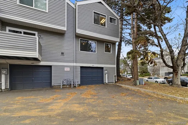 a view of a house with a yard and garage