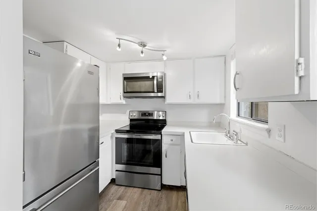 a kitchen with a sink appliances and cabinets