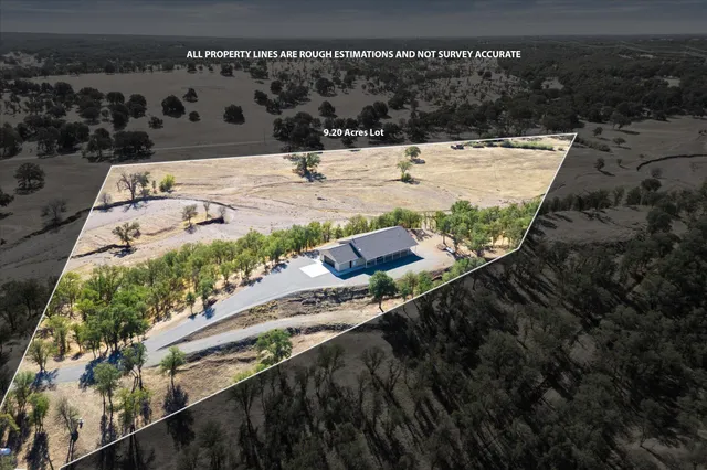 a view of a backyard with wooden fence