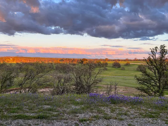 a view of a large building with mountains in the background