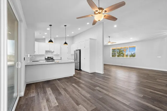 a large kitchen with a large window appliances and cabinets