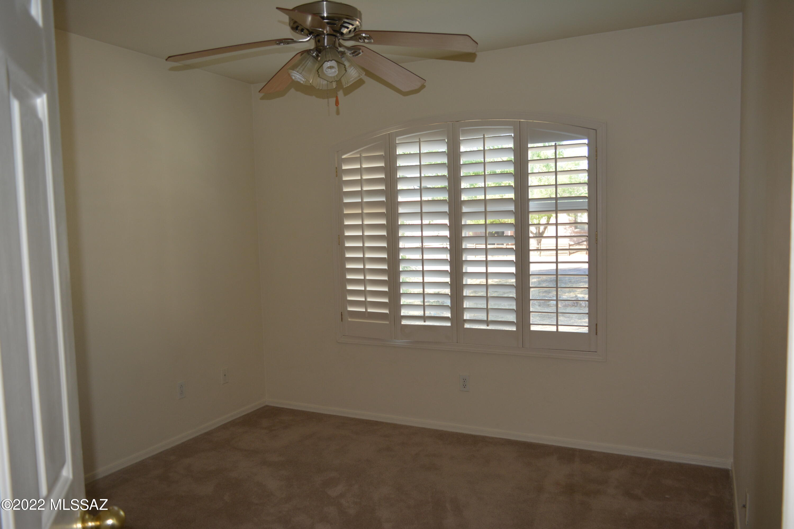 1714 Camino Rivera Rio Rico, AZ 85648 - Photo 20 of 26 an empty room with a window and a fan