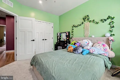 a bedroom with a bed and a potted plant