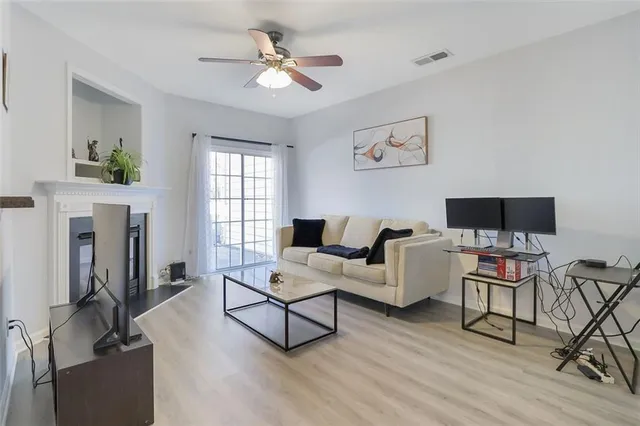 a living room with furniture a fireplace and a flat screen tv