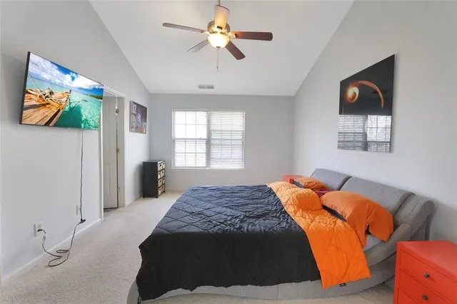 a bedroom with a bed and a painting on the wall