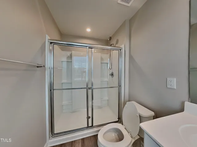 a bathroom with a sink mirror and toilet