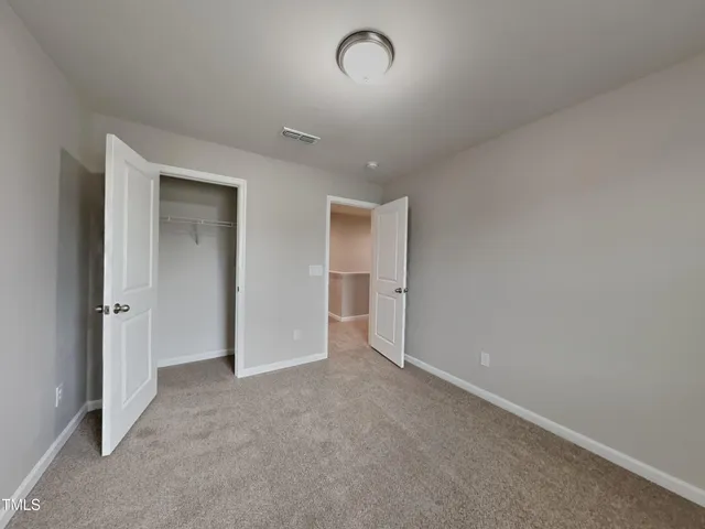 a view of an empty room and a window
