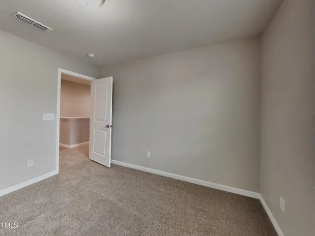 a view of an empty room and a window