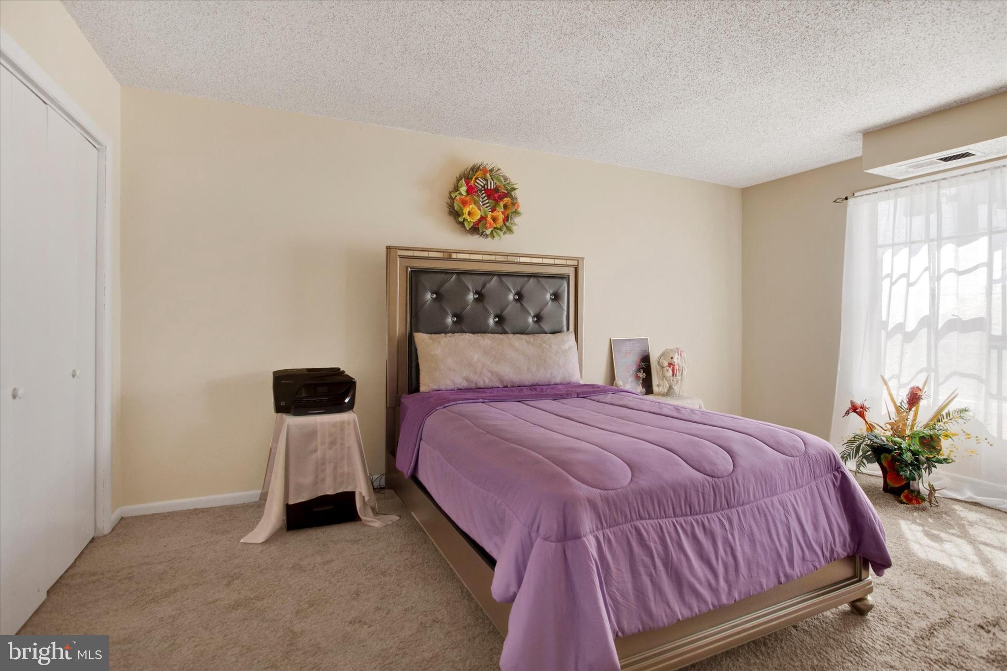 3805 Swann Road, Unit 304 Suitland, MD 20746 - Photo 12 of 16 a bedroom with a bed and a painting on the wall