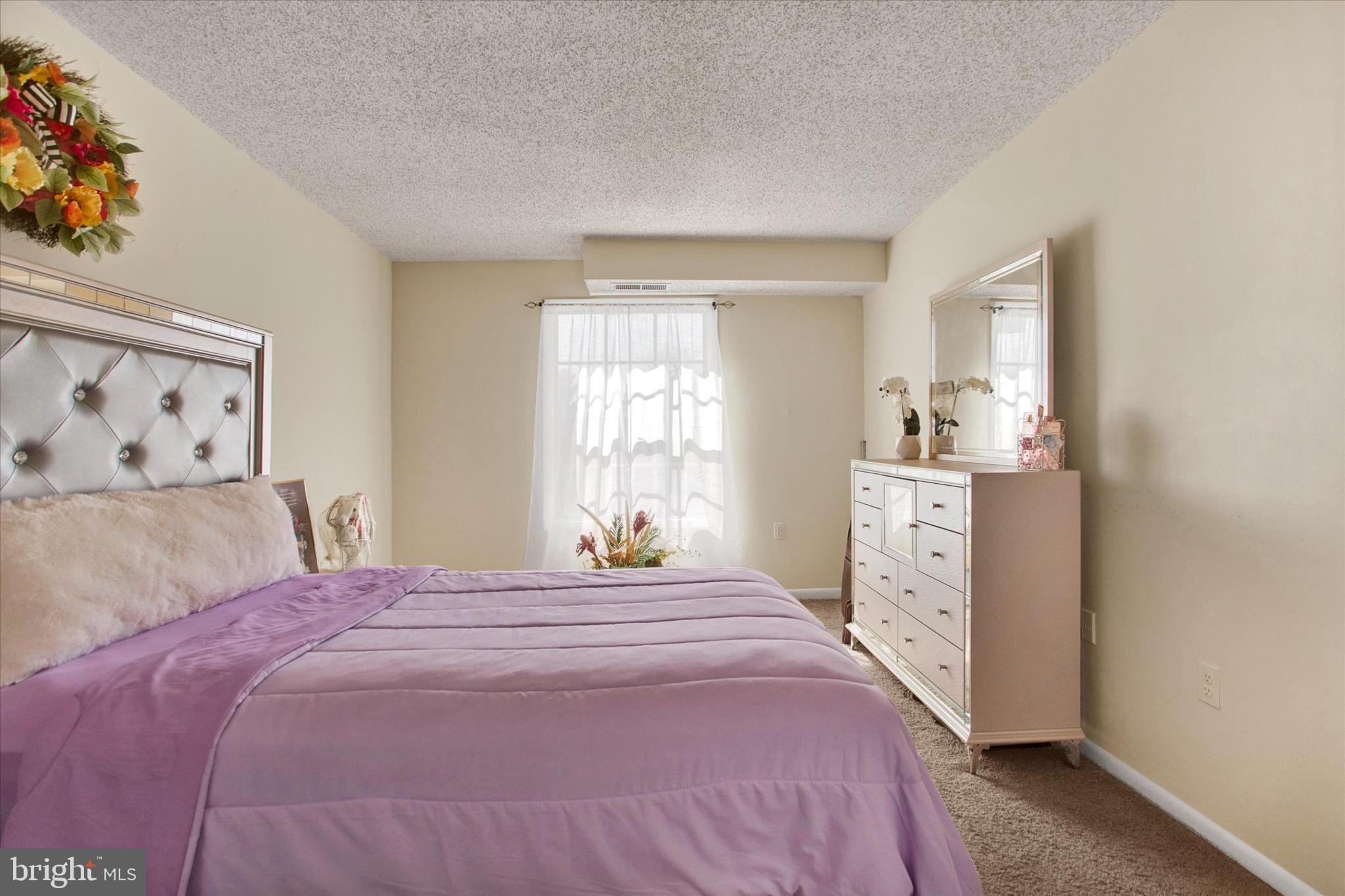 3805 Swann Road, Unit 304 Suitland, MD 20746 - Photo 13 of 16 a bedroom with a bed and a window
