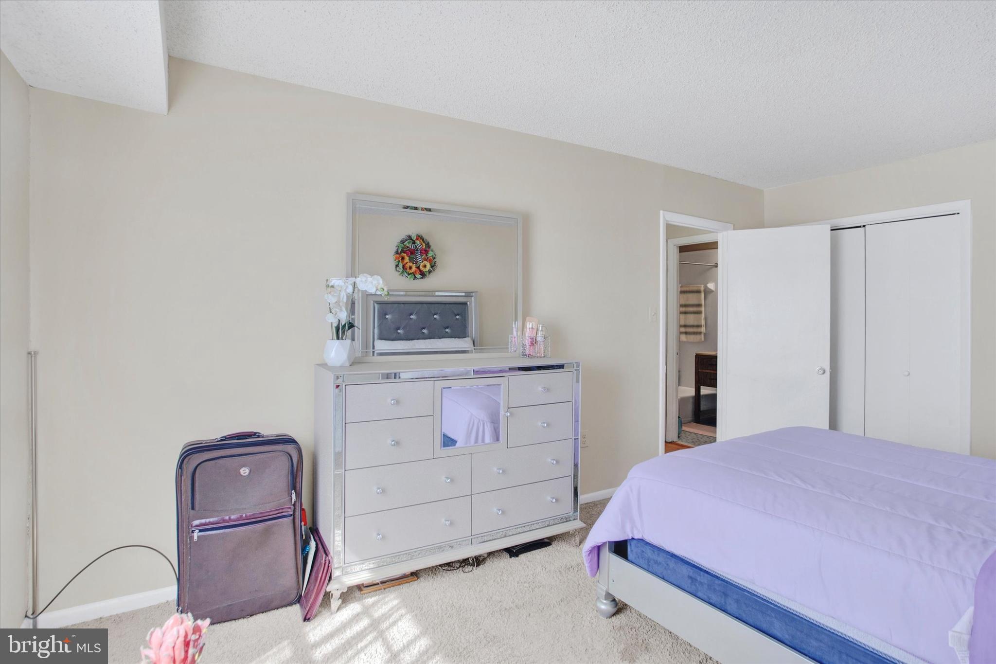 3805 Swann Road, Unit 304 Suitland, MD 20746 - Photo 14 of 16 a bedroom with a bed and dresser