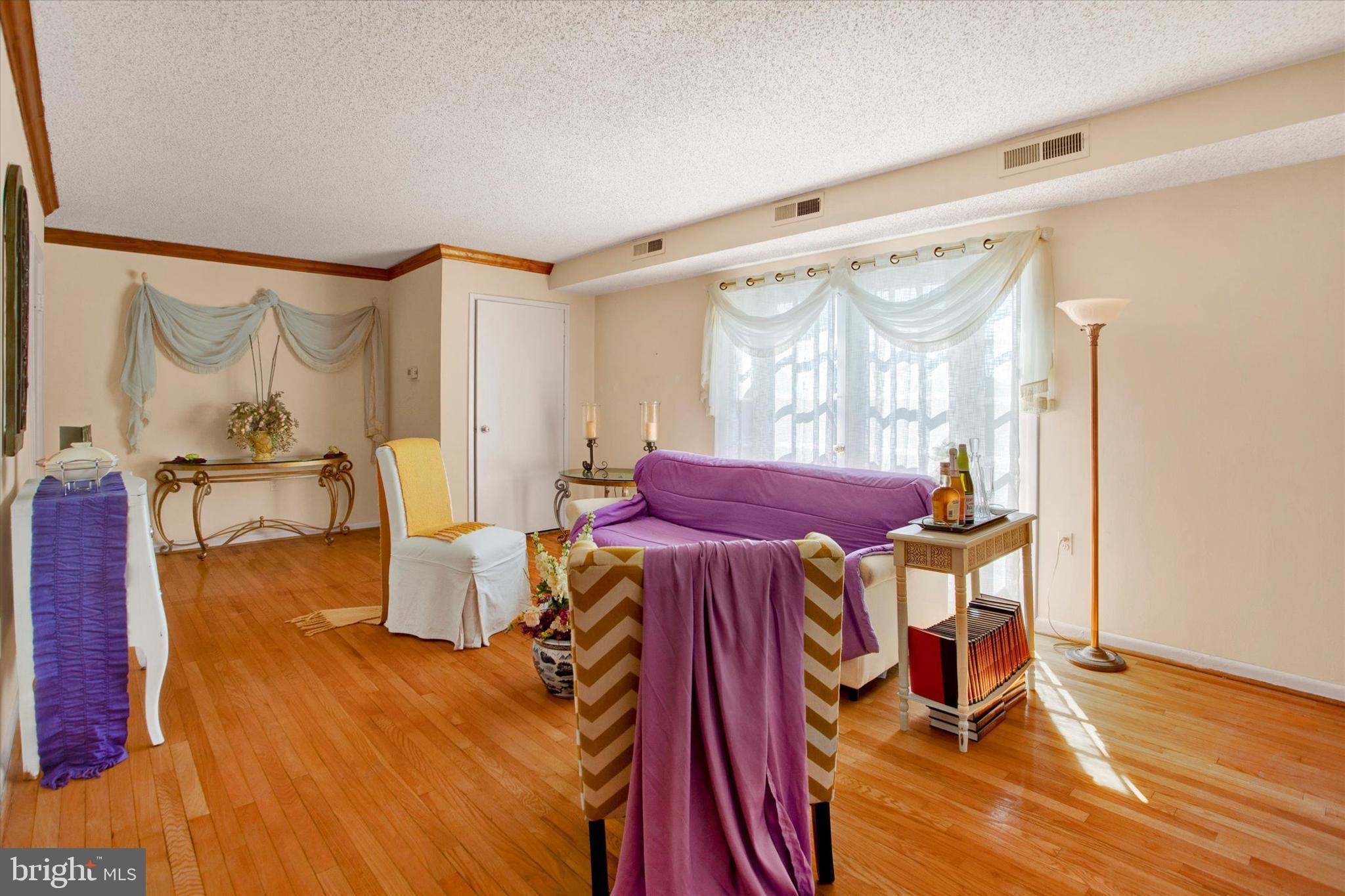 3805 Swann Road, Unit 304 Suitland, MD 20746 - Photo 3 of 16 a view of a dining room with furniture a chandelier and wooden floor