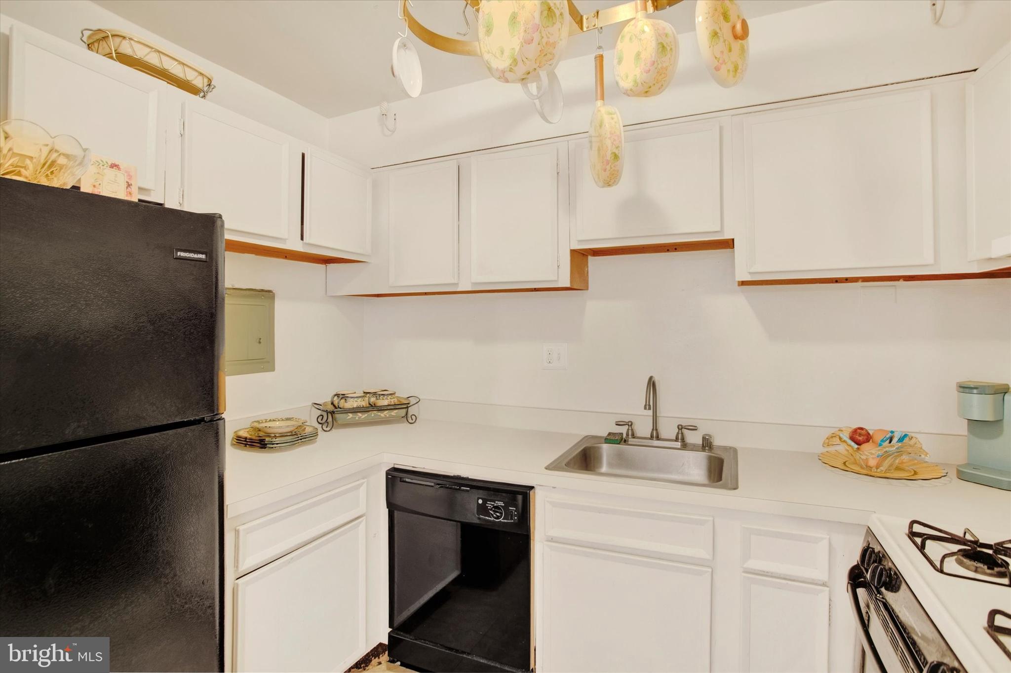 3805 Swann Road, Unit 304 Suitland, MD 20746 - Photo 8 of 16 a kitchen with a sink and a refrigerator