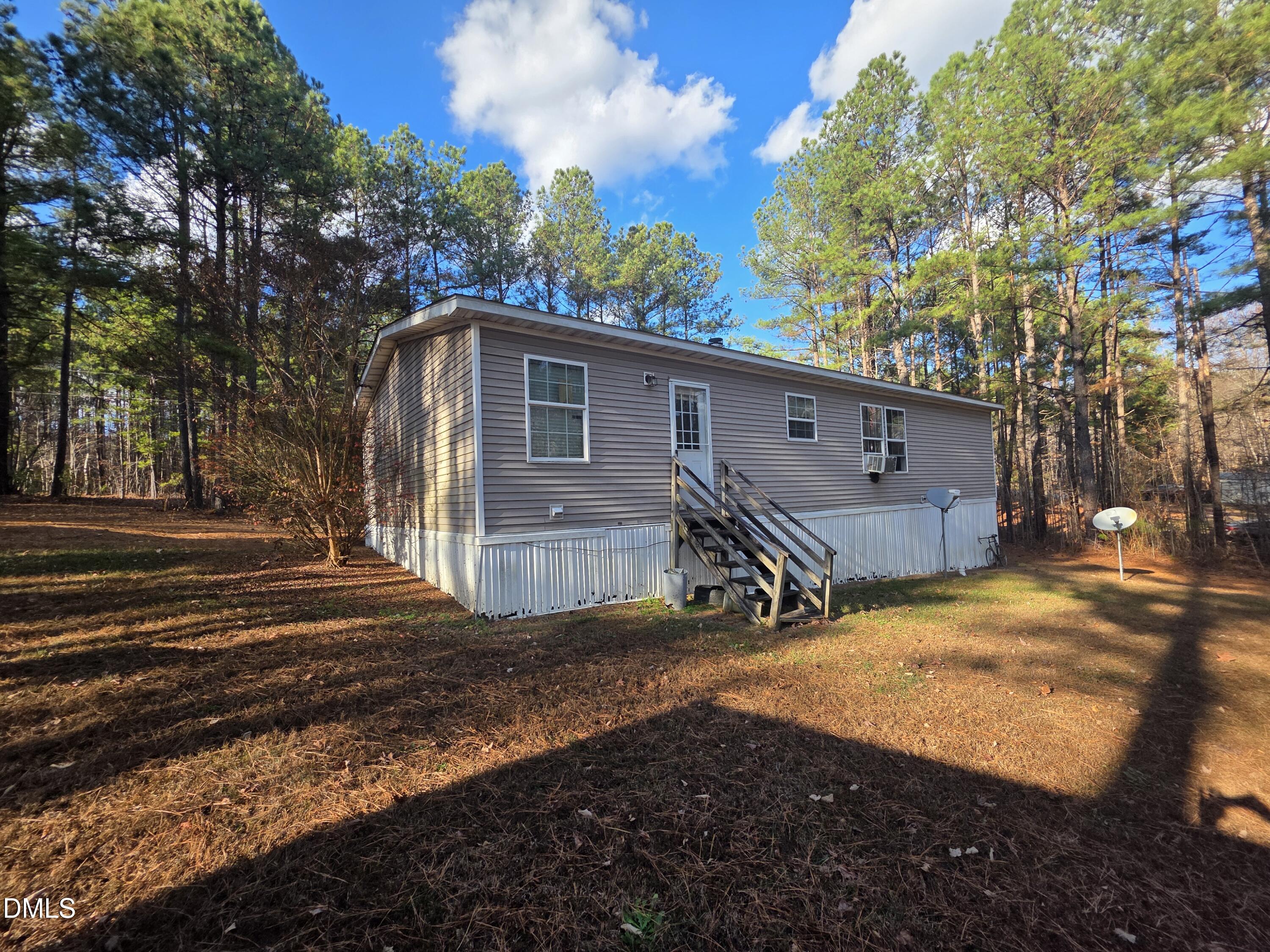 664 Glebe Road Henderson, NC 27537 - Photo 2 of 3 a view of a house with backyard and a tree