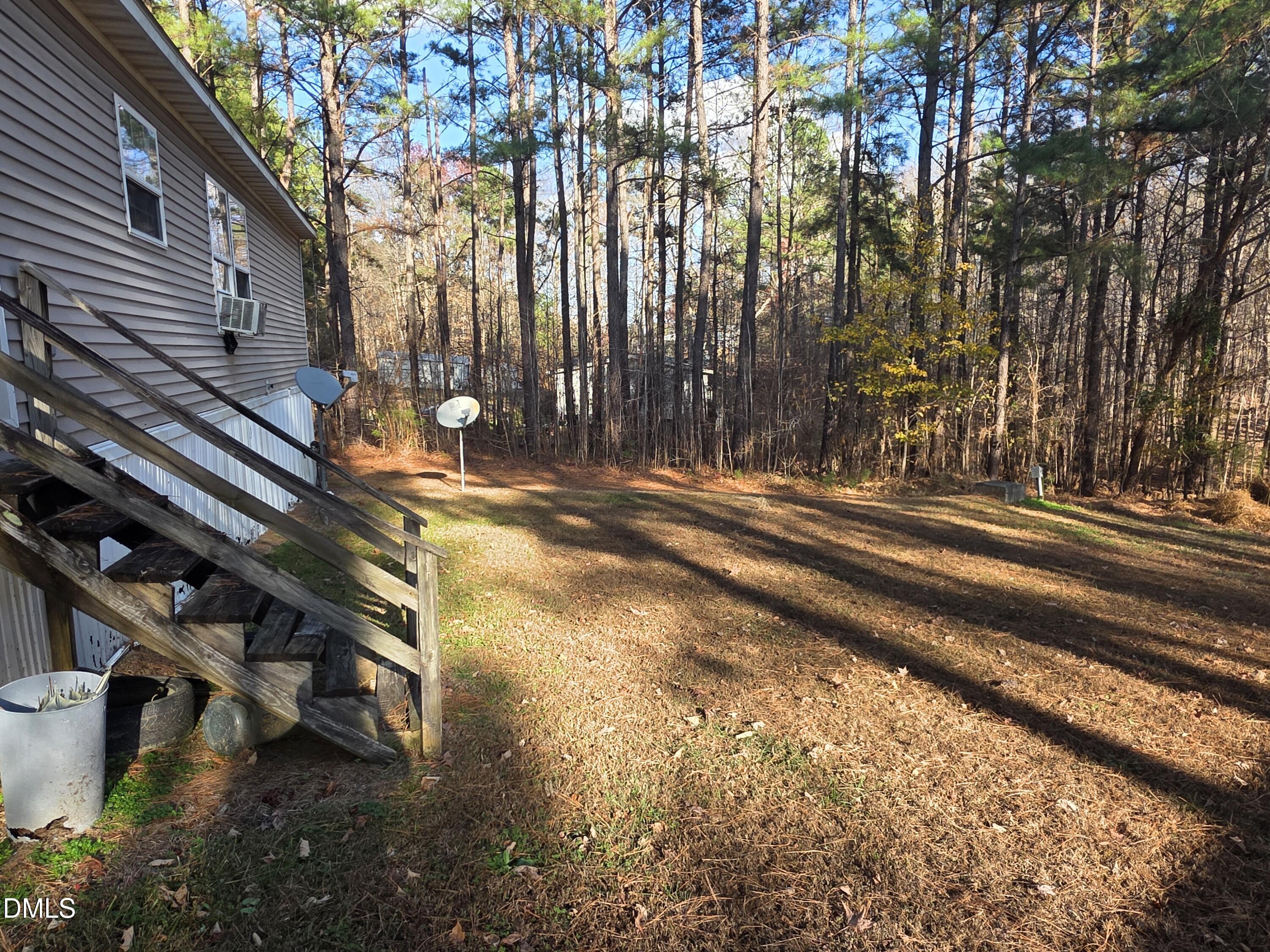 664 Glebe Road Henderson, NC 27537 - Photo 3 of 3 a backyard of a house with lots of green space