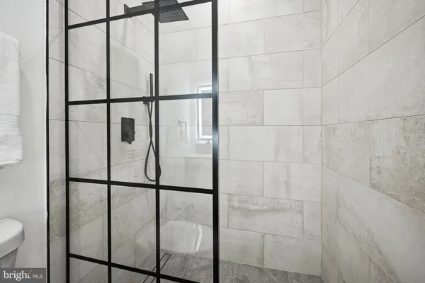 a bathroom with a glass shower door