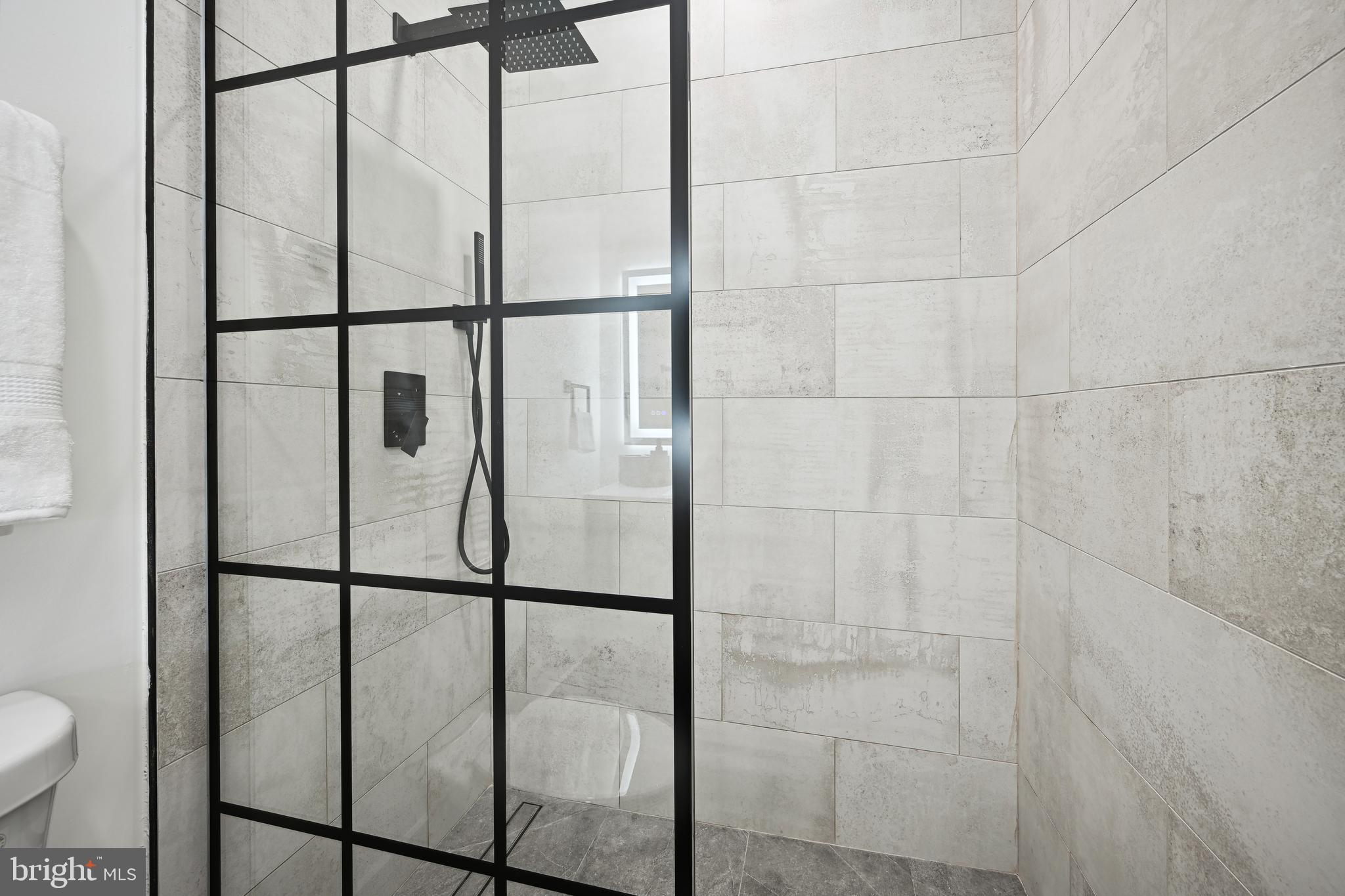 1372 Bryant Street Northeast, Unit 2 Washington, DC 20018 - Photo 14 of 22 a bathroom with a glass shower door