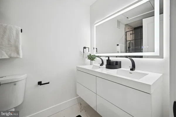 a bathroom with a sink toilet and mirror