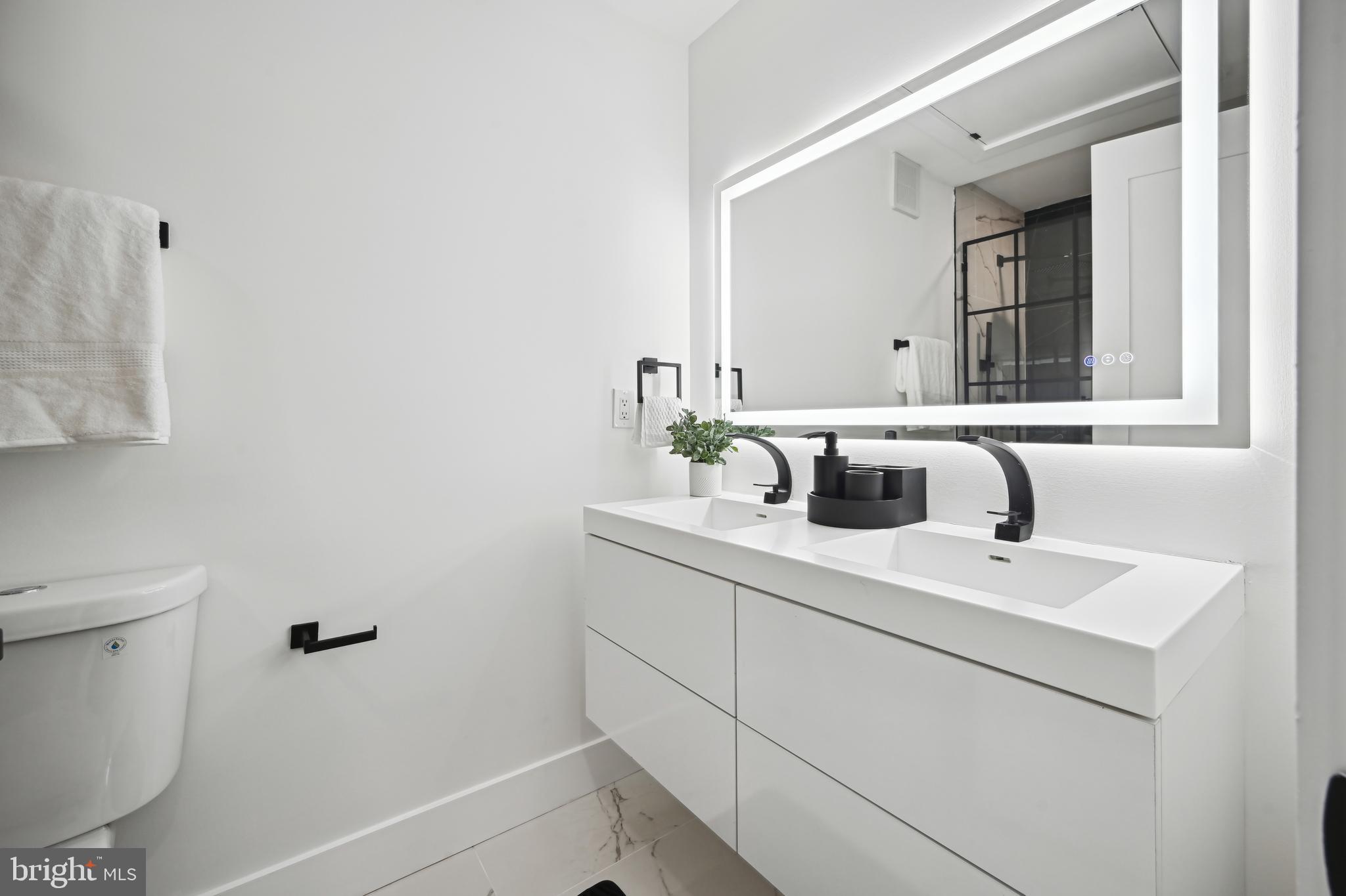 1372 Bryant Street Northeast, Unit 2 Washington, DC 20018 - Photo 17 of 22 a bathroom with a sink toilet and mirror