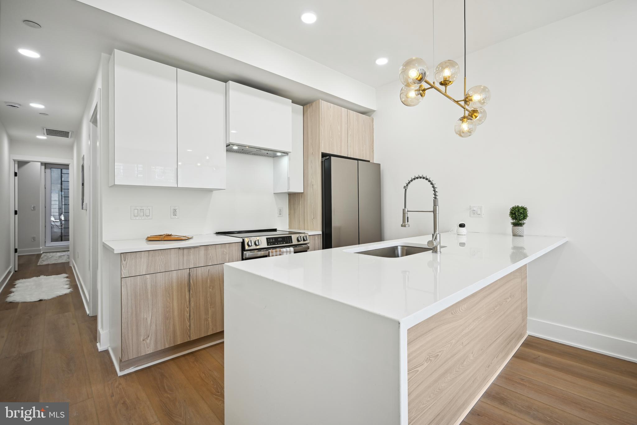 1372 Bryant Street Northeast, Unit 2 Washington, DC 20018 - Photo 7 of 22 a kitchen with a sink and a refrigerator
