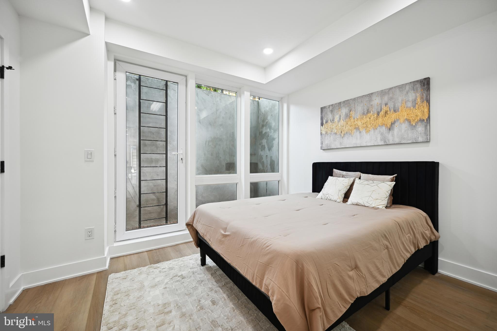 1372 Bryant Street Northeast, Unit 2 Washington, DC 20018 - Photo 10 of 22 a bedroom with a large bed and a window