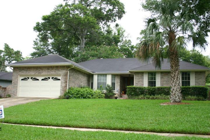 a front view of a house with a yard and a garage