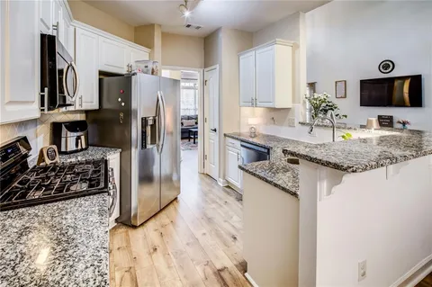 a living room with furniture wooden floor and flat screen tv
