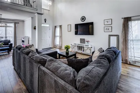 a living room with furniture a rug and a window