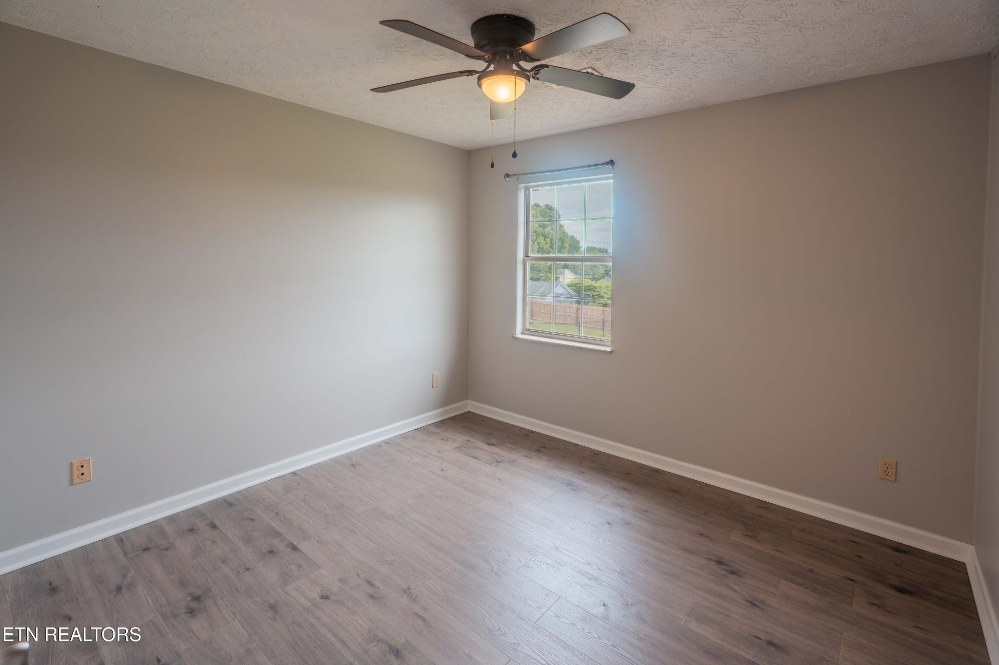 7722 Ashcroft Way Powell, TN 37849 - Photo 16 of 24 wooden floor in an empty room with a window