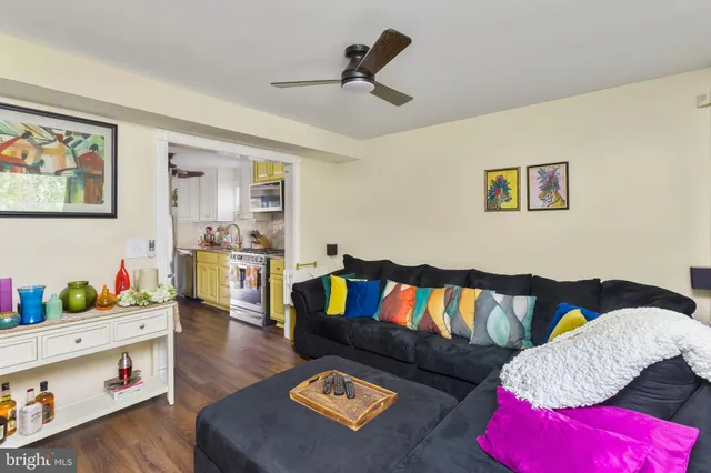 a living room with furniture and a book shelf