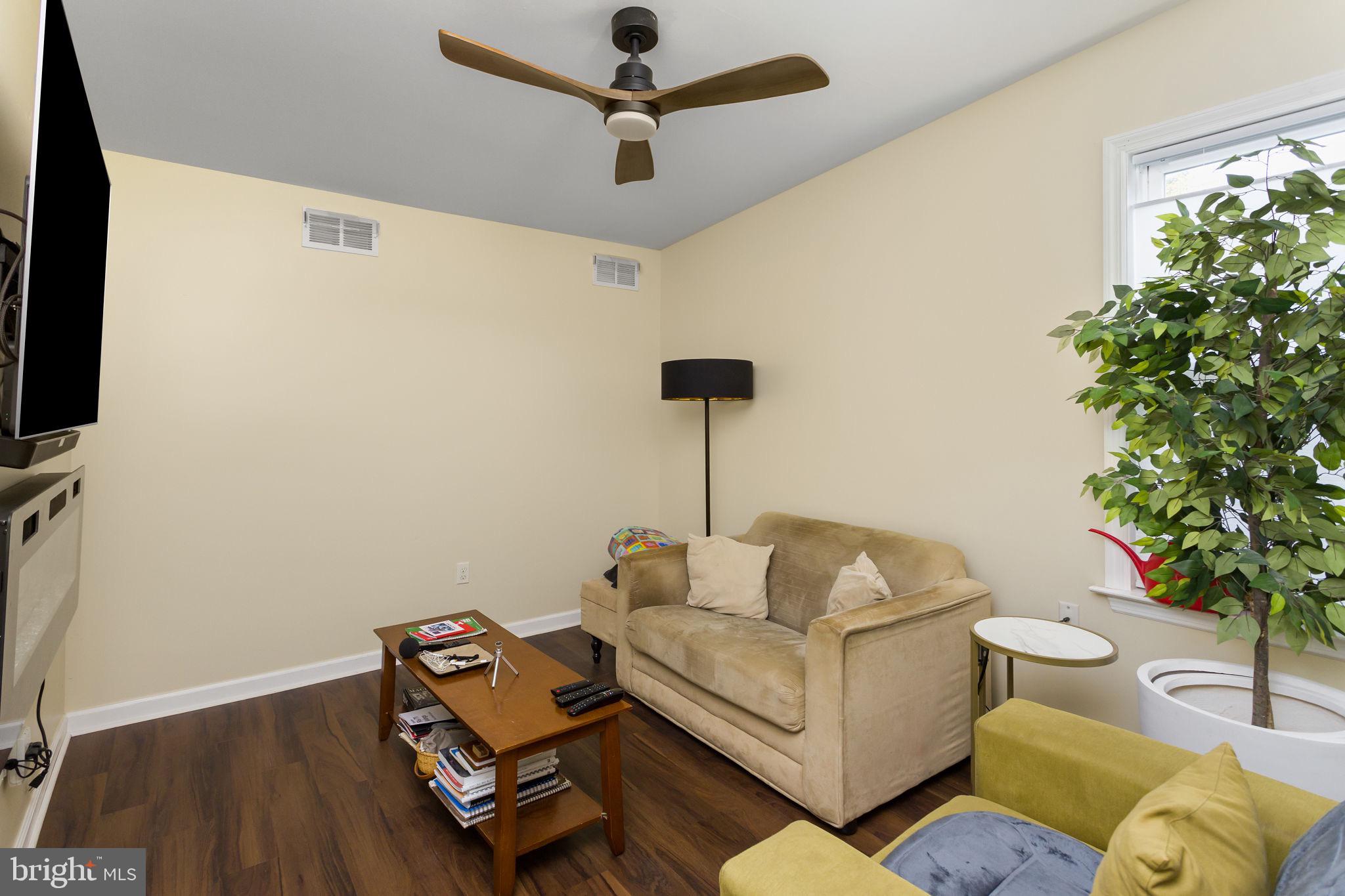 227 Princeton Avenue Hamilton, NJ 08619 - Photo 19 of 41 a living room with furniture and a potted plant