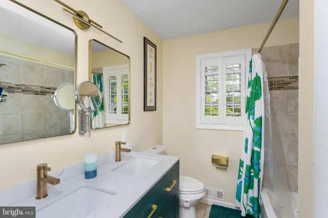 a bedroom with a bed and a flat tv screen on dresser