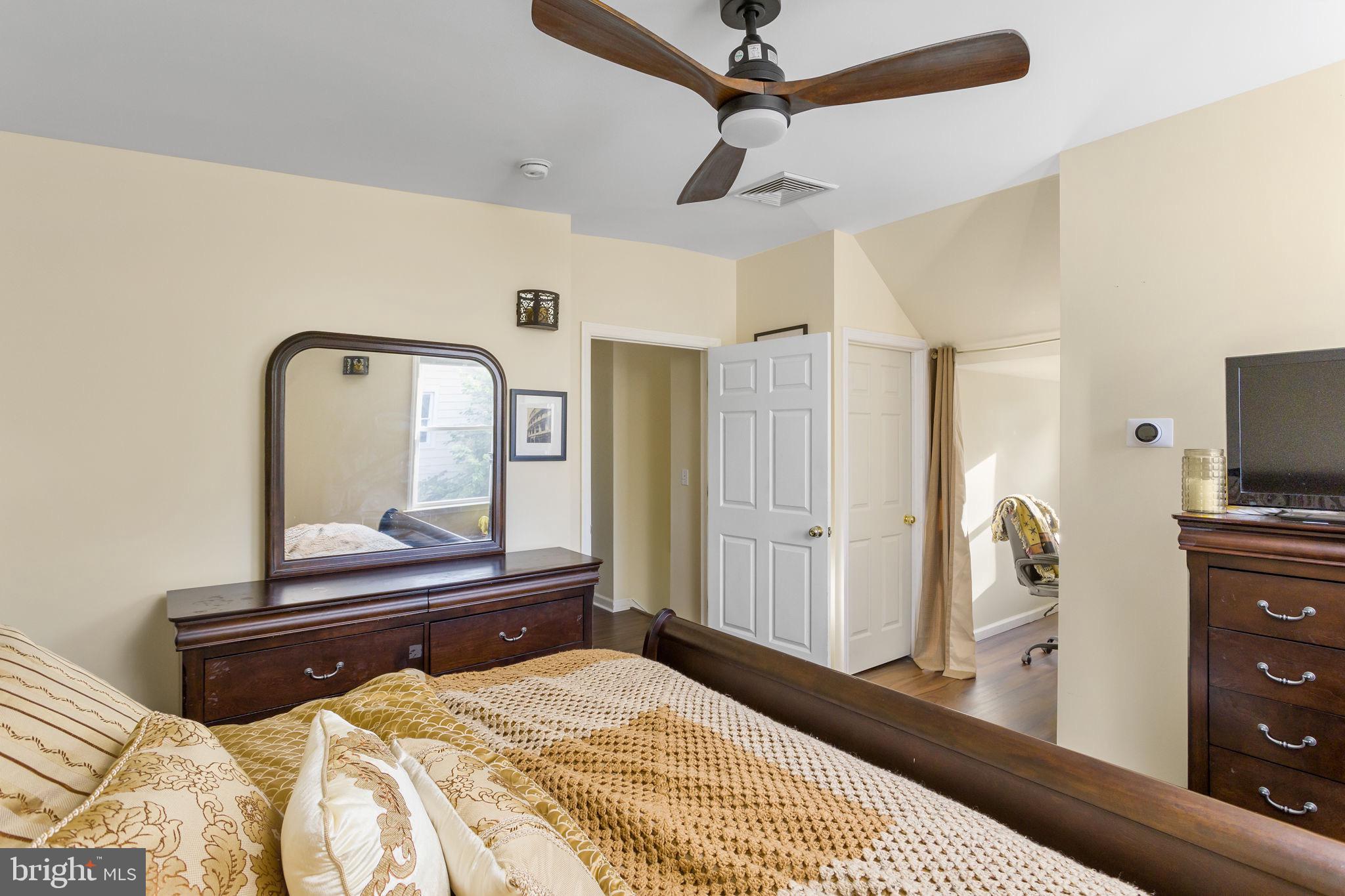 227 Princeton Avenue Hamilton, NJ 08619 - Photo 25 of 41 a bedroom with a bed and a flat tv screen on dresser