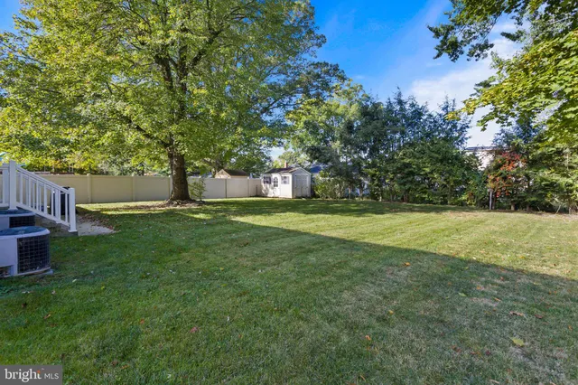an aerial view of a house with a yard large trees