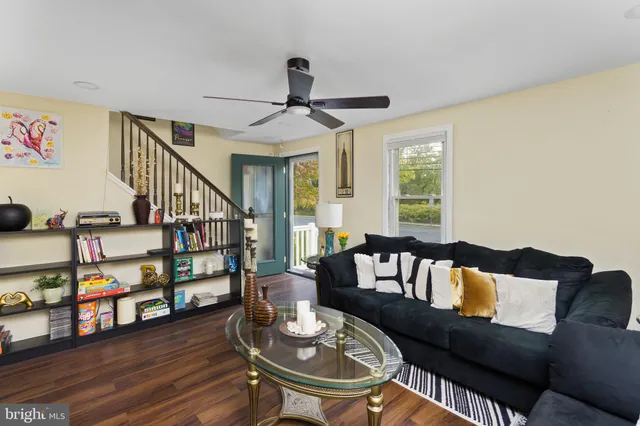 a living room with furniture and a wooden floor