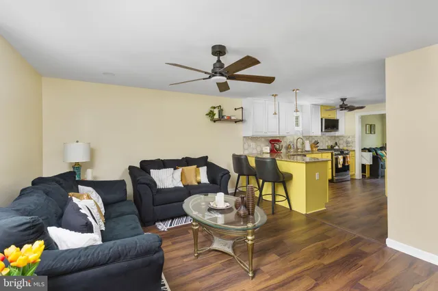 a living room with furniture and kitchen view