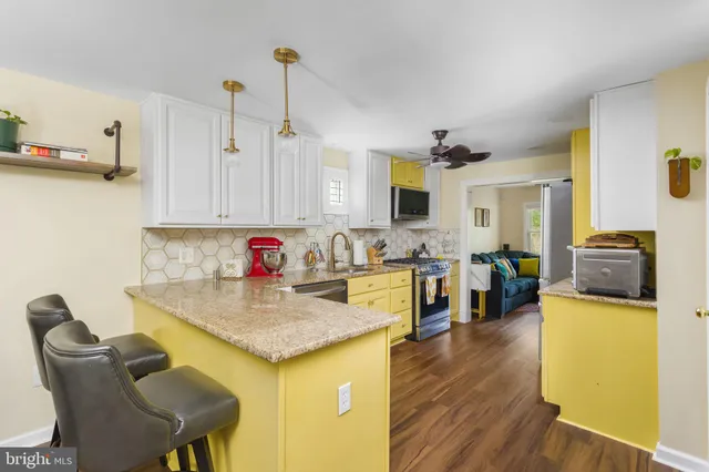 a view of kitchen with sink and wooden floor