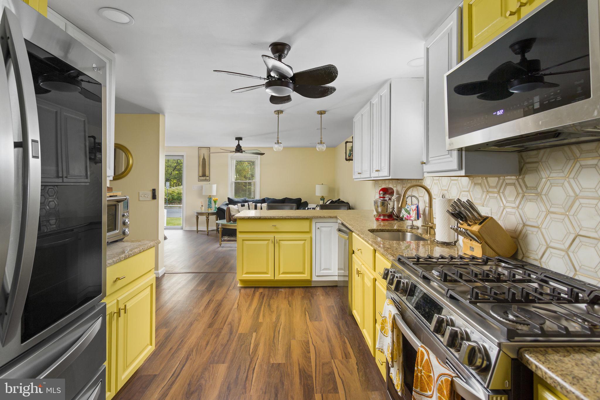 227 Princeton Avenue Hamilton, NJ 08619 - Photo 9 of 41 a kitchen with stainless steel appliances a stove a sink and a refrigerator