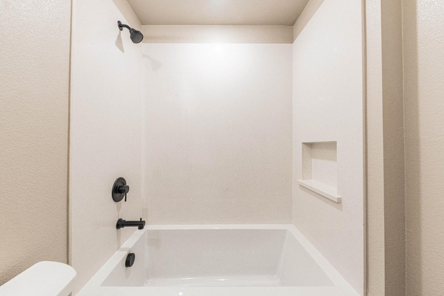135 8th Street Marina, CA 93933 - Photo 50 of 69 a bathroom with a bathtub and a shower