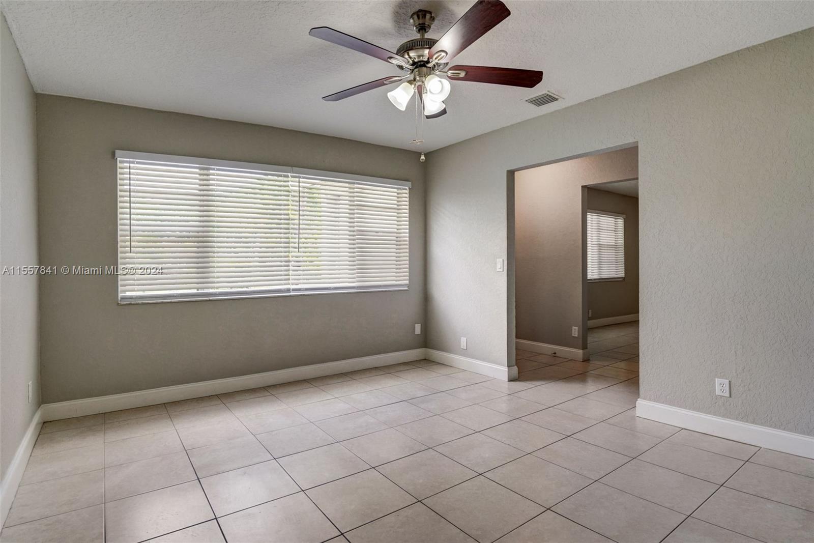 17395 Bendross Road Jupiter, FL 33458 - Photo 9 of 28 a view of an empty room with a window