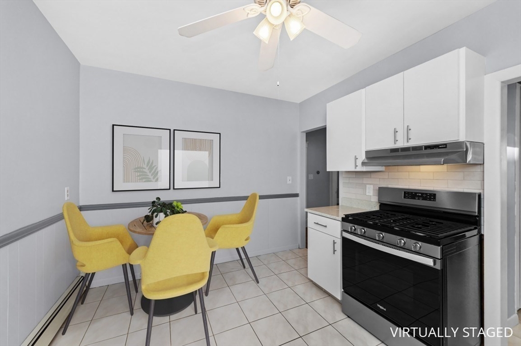 14 St Marys Street, Unit 2 Watertown, MA 02472 - Photo 6 of 14 a kitchen with table chair and stove top oven