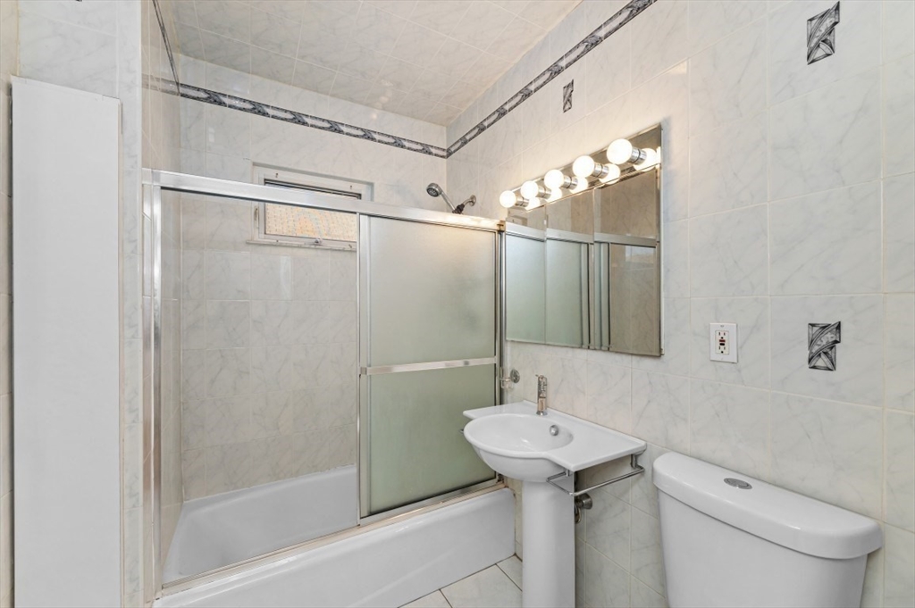 14 St Marys Street, Unit 2 Watertown, MA 02472 - Photo 8 of 14 a bathroom with a sink a toilet and shower