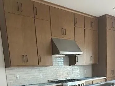 a stove top oven sitting inside of a kitchen