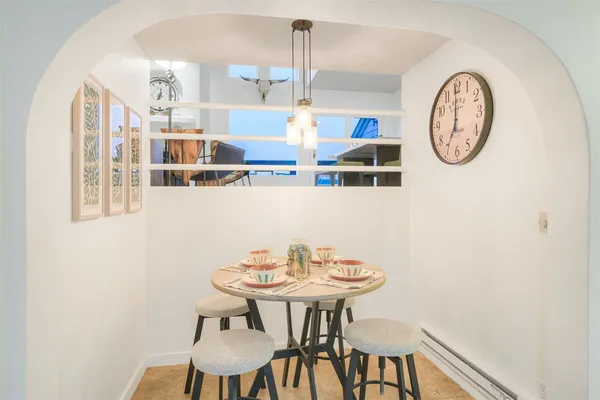 a view of a dining room with furniture and a flat screen tv