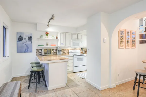 a bathroom with a sink mirror toilet and bathtub