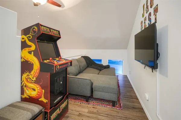 a backyard of a house with basket ball court tables and chairs