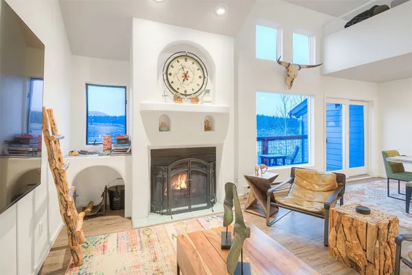 a living room with furniture a clock and a fireplace