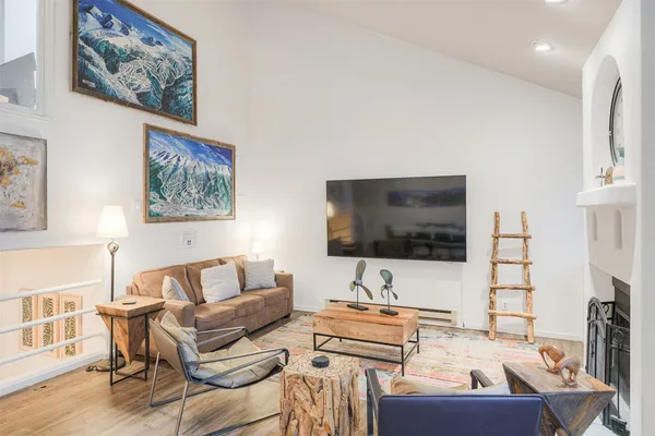 a living room with furniture and a painting on the wall